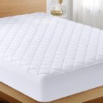 The Utopia Bedding Quilted Fitted Mattress Pad in Queen Size is an elastic fitted mattress topper protector and cover that stretches up to 16 inches deep